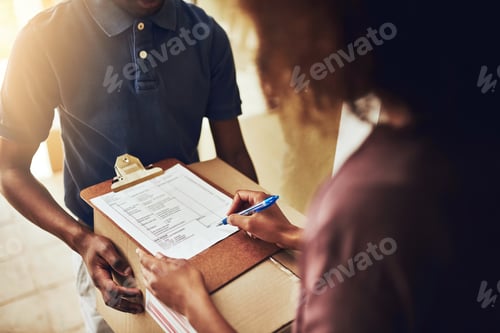 Preview: High angle shot of an unrecognizable woman signing for a home delivery