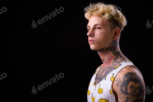 Preview: Young handsome rebellious man with blond hair and tattoos