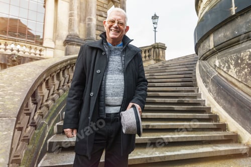 Preview: Senior man exploring city standing on stairway, Dresden, Sachsen, Germany