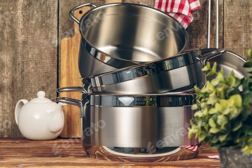Vista previa: Set of stainless steel saucepans in a kitchen