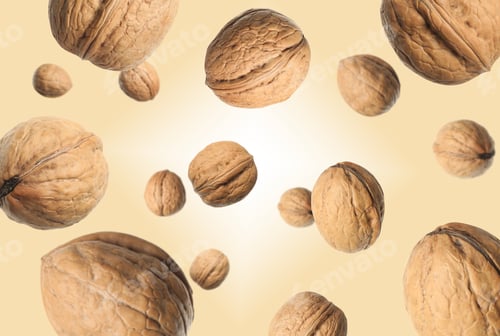 Preview: Walnuts in shell swirling in air against dark beige background