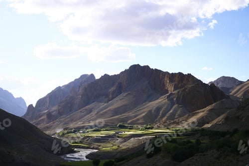 Preview: Scenic view of a mountainous landscape in daylight in cloudy sky background