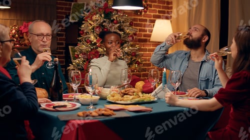 Preview: Happy african american woman inviting family members to toast while celebrating winter holiday