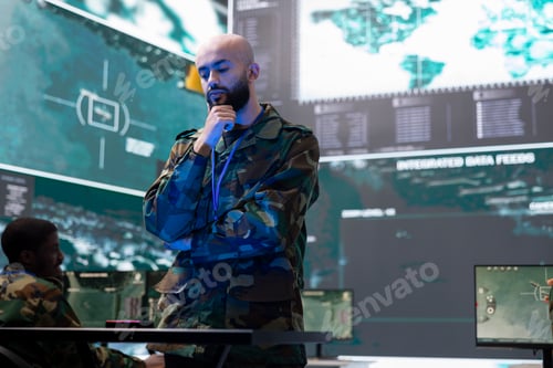 Preview: Army conscript studying real time data on a hologram in control center