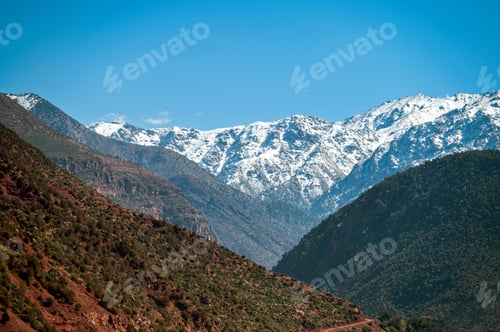 Preview: Majestic Atlas Mountains in Morocco with Snow-Capped Peaks Under Clear Blue Sky