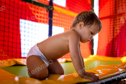 Preview: Brother and older sister are playing in the playroom and jumping on a trampoline on a summer day