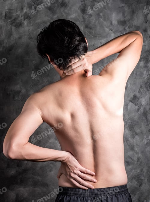 Preview: a man with back pain on grey background