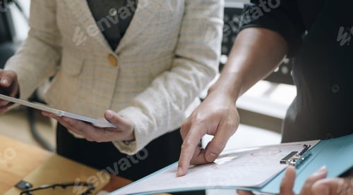 Preview: Teamwork with business people analysis cost graph on desk at meeting room.