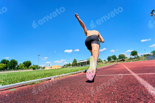 Preview: A man running on a track with a blue sky in the background