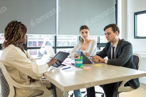 Preview: Diverse colleagues gather in brainstorm discuss statistics together.