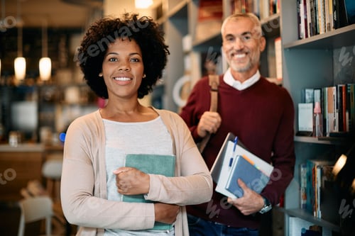 Preview: Portrait of happy non traditional students at university library looking at camera.