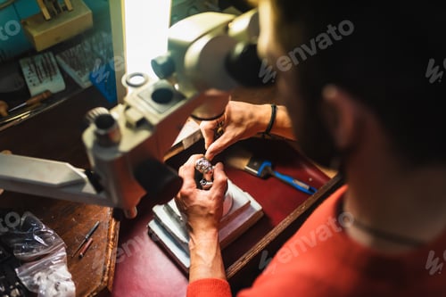 Preview: Unrecognizable jeweler hands working on a piece of jewelry