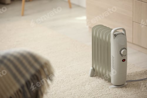 Preview: Modern electric heater on floor at home