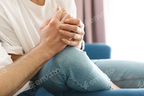 Preview: Couple holding each other hands at home