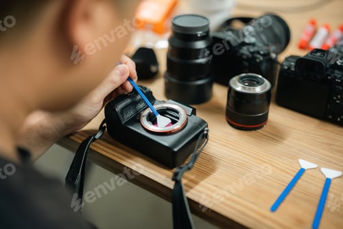 Preview: Precision at Work: Camera Technician Expertly Cleans Sensor for Photography Equipment Performance