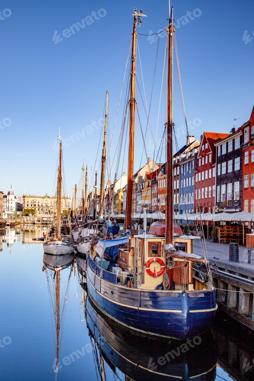 Preview: COPENHAGEN, DENMARK - MAY 6, 2018: moored boats at harbor near buildings in Copenhagen, Denmark