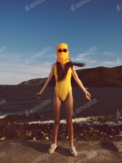 Preview: Beach, woman, swimsuit, mask a woman in a yellow swimsuit and yellow mask stands on a sunny beach