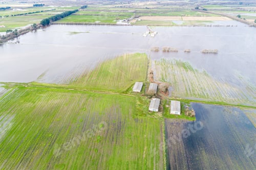 Preview: drone aerial view of a farm on flooded agricultural land after spring rains, climate change concept