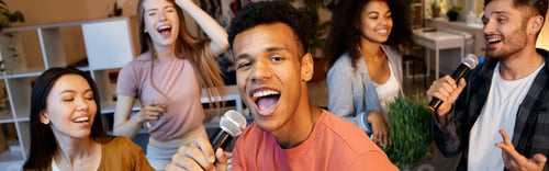 Preview: Radiate fun. Enthusiastic young guy singing with microphone while playing karaoke with friends in