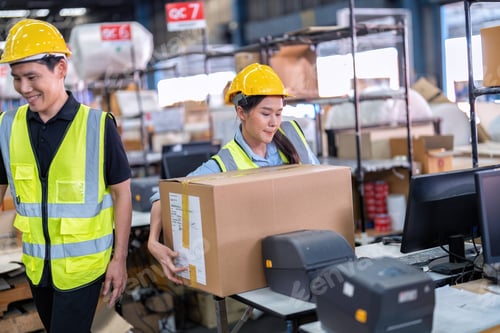 Preview: 2 Staff working in large depot storage warehouse check packing box and scan at cashier counter