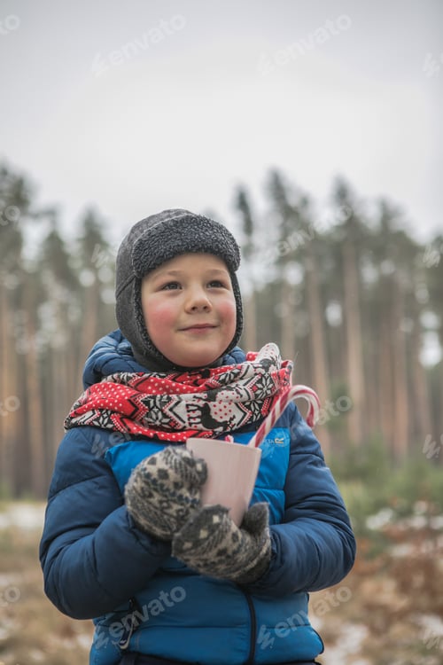 Preview: Christmas holidays, boy drinking hot New Year beverage. Happy family