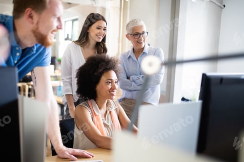 Preview: Team of colleagues brainstorming together while working in modern office