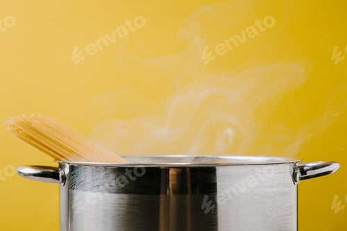 Preview: delicious spaghetti boiling in stewpot isolated on yellow
