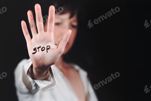 Preview: Woman's hand with written stop