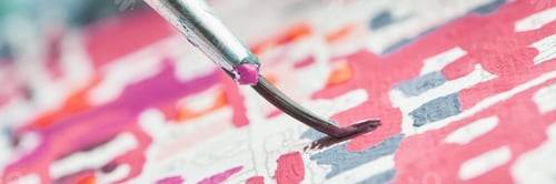 Preview: Close-up of paintbrush applying vibrant colors on abstract canvas artwork