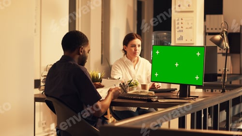 Preview: African american man working with greenscreen on computer