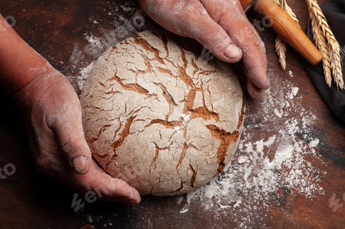 Preview: Baker holding fresh baked homemade bread