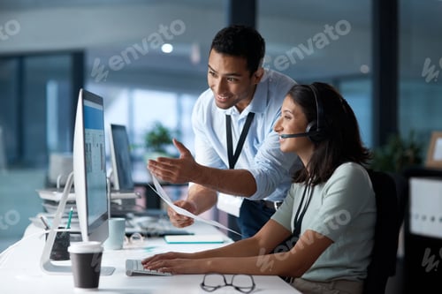 Preview: Shot of a young man and woman using a computer while working in a call centre