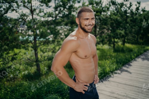 Preview: Cheerful sporty man works out in nature, enjoys athlete exercising