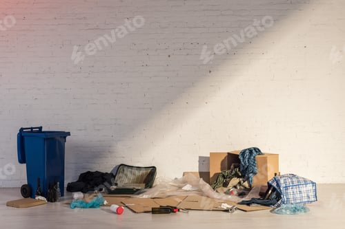 Preview: blue trash container and rubbish dump on brick wall background