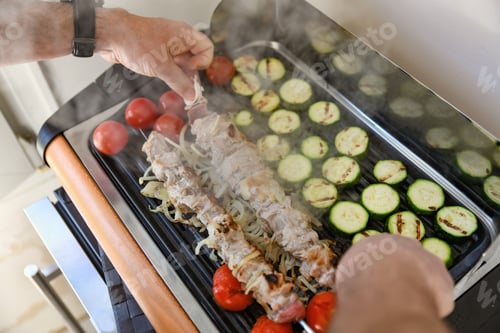 Preview: Man preparing barbecue and vegetables