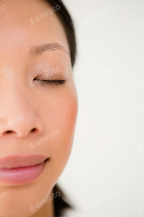Preview: Relaxing at spa, serene asian woman enjoying peaceful moment with eyes closed