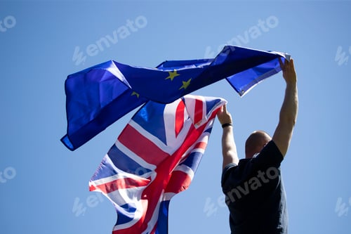 Preview: UK England Flag and European Union EU Flag holded by a man.