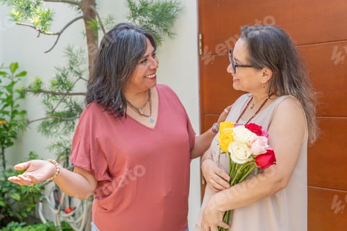Preview: Two Women Smiling Near a Wooden Door
