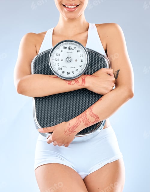 Preview: Shot of an unrecognizable woman holding a weighing scale against a grey background