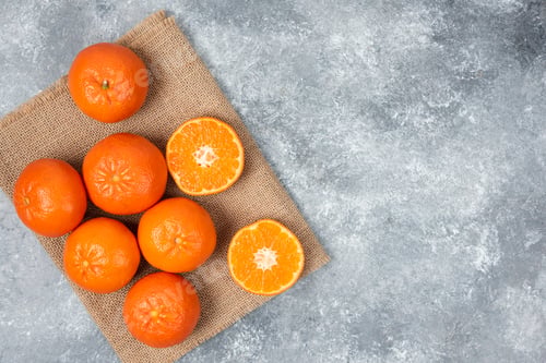 Preview: Juicy orange fruits with slices on stone background