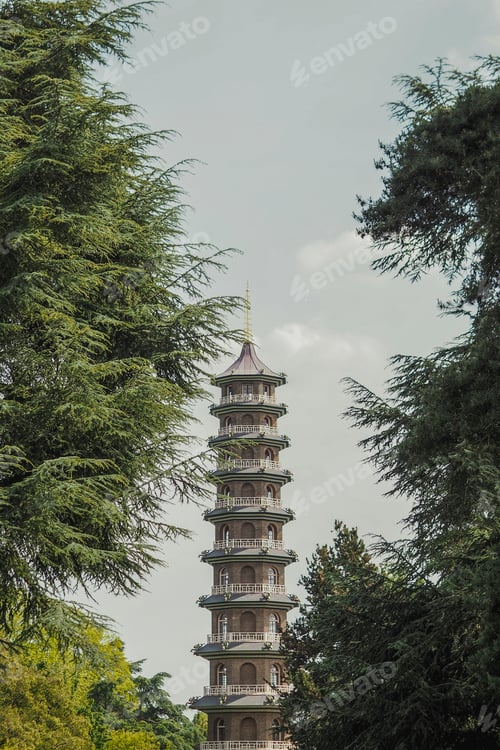 Preview: Stone tall Chinese Tower standing amidst trees and plants in a park