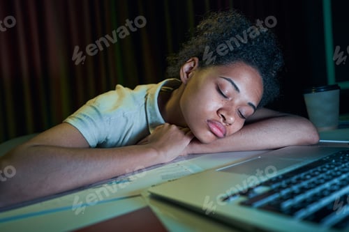 Preview: Sleepy woman working overtime at night in office