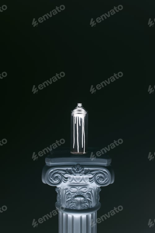 Preview: close up view of spray paint in can standing on column isolated on black