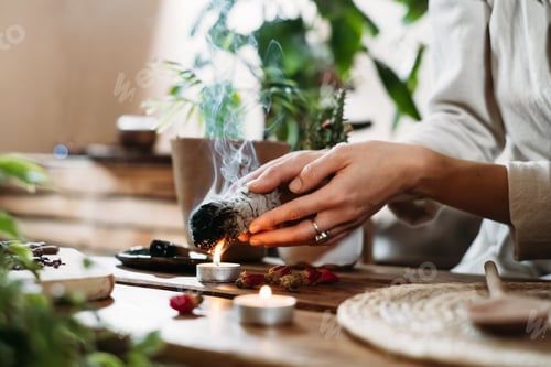 Preview: Hands burning white sage for ancient spiritual ritual