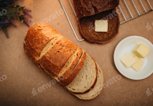 Preview: Freshly baked Artisan bread on brown table with butter