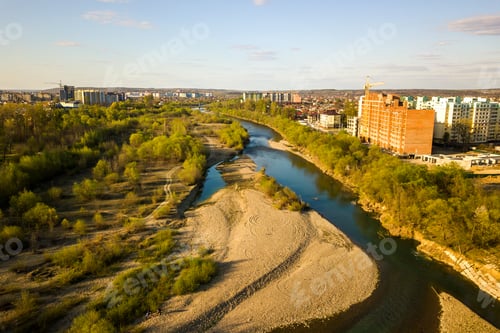 Preview: Aerial view of tall residential apartment buildings under construction and Bystrytsia river