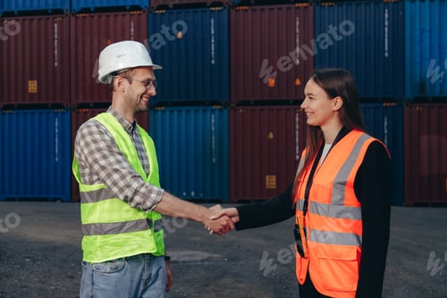 Preview: People at work: man and woman hand shaking at shipping terminal with containers in background