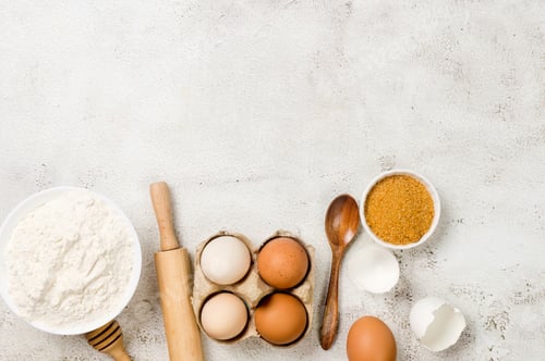 Preview: Ingredients for baking background. Eggs, flour, cinnamon, sugar, soda on the kitchen table.