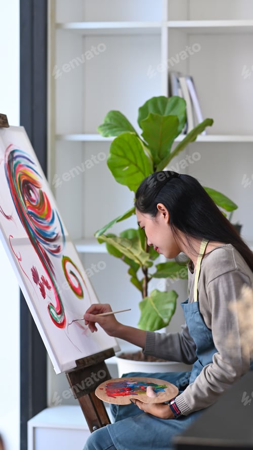 Preview: Young asian woman painter painting on canvas in art studio.