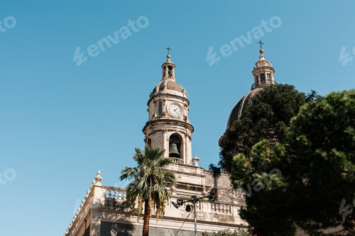 Preview: CATANIA, ITALY - OCTOBER 3, 2019: low angle view of clock tower of Saint Agatha cathedral